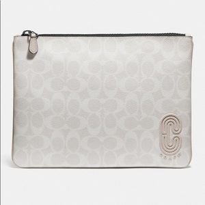 Pouch in signature canvas with Coach patch